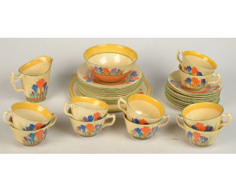 A Clarice Cliff 'Crocus' pattern tea service comprising eight cups and ten saucers, 8cm plates, a cake plate, a milk jug and 