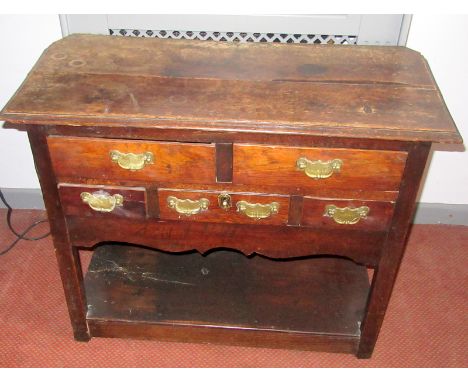 A rare, 18th century oak side table in the form of a low dresser, fitted two drawers over three small drawers, a shaped apron