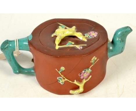 A Chinese Yixing pottery teapot, 19th century, with glazed handle, cover and spout, the body decorated with flowering vines, 