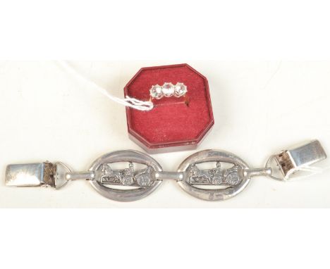 A dress ring and a silver coloured metal cloak clasp.