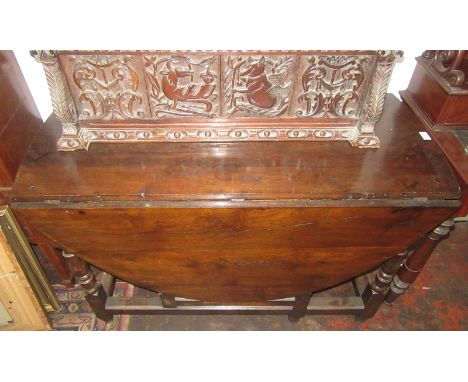 An early 18th century oak gate leg oval dining table fitted two drawers.
