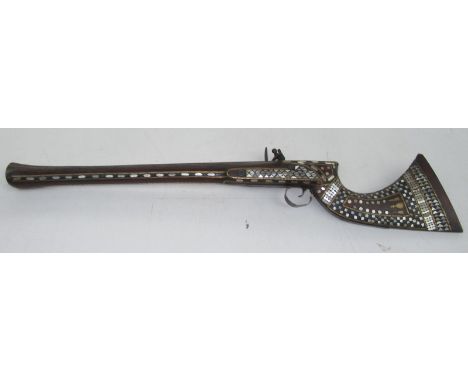 An early 19th century Jezail flintlock blunderbuss, the stock with mother of pearl inlay and brass mounts, the 60cm barrel fl