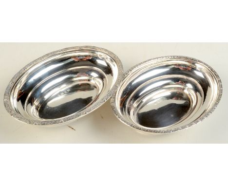 A pair of post war oval small silver bowls with Celtic strapwork borders, 5oz.