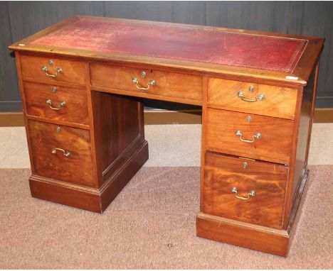 MAHOGANY OBLONG PEDESTAL WRITING DESK OF GEORGE III DESIGN the top inlaid a tooled red leather panel, with three frieze drawe