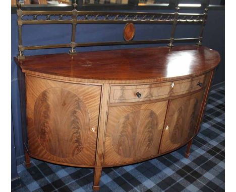 EDWARDIAN MAHOGANY CROSSBANDED BOW-FRONT STAGE SIDEBOARD the central frieze drawer with cupboard below enclosed by two panel 