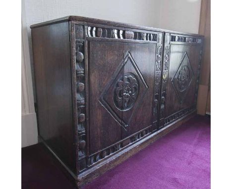 OAK TWO DOOR DWARF CUPBOARD OF 17TH CENTURY DESIGN the top with an arcaded frieze, cupboard below enclosed by two lozenge car