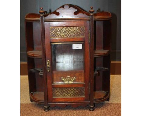 VICTORIAN OAK AND BRASS SMOKERS' CABINETthe glazed central door opening to reveal a recess for a tobacco jar above two short 