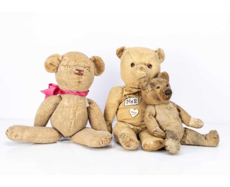 Three character teddy bears,  the largest with remains of blonde mohair, orange and black plastic eyes,  M .E patch to chest 