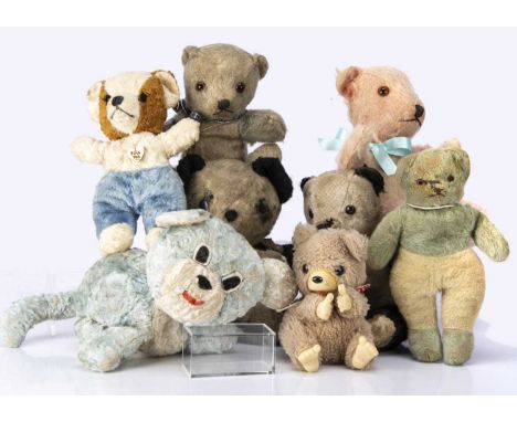 Eight vintage baby/ toddler soft toys,  including a Chiltern pink and white unjointed bear, with orange and black glass eyes,