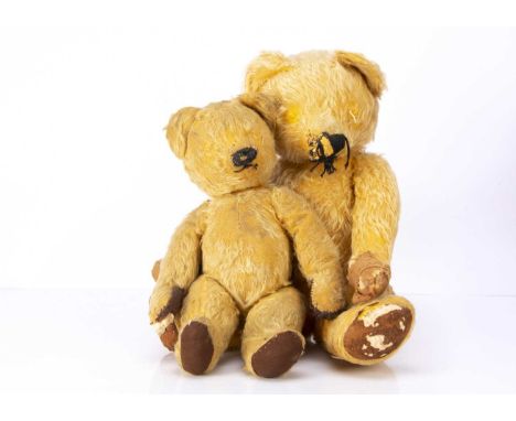 Two post war Chad Valley teddy bears, the larger with golden mohair, black stitched nose mouth and claws, swivel head and joi