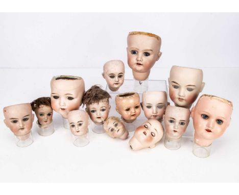 Fourteen doll heads,  including a Morimura 10 (Japan) bisque headed baby with blue sleeping eyes, red felt replacement tongue