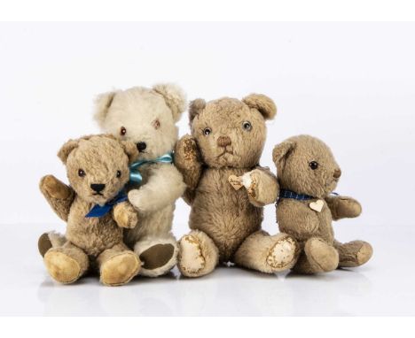 Three Invicta teddy bears, the largest with light brown wool plush, clear and black glass eyes, brown stitched nose and mouth