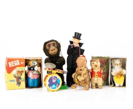 Six wind up vintage toys,  including a knitting cat in original box, a bear with flash camera in original box, a gorilla play