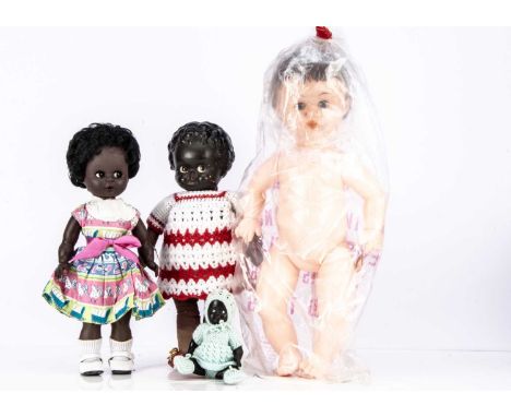 Three Palitoy black dolls,  a Palitoy doll with plastic head, brown painted side glancing eyes, red lips, moulded hair, cloth