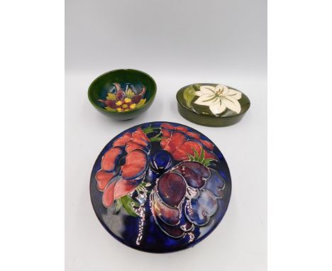 3 Walter Moorcroft pieces to include A candy box and cover in the Anemone Blue design c1980, approximate diameter 14cm, with 