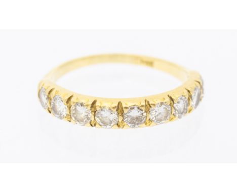 A diamond and 18ct gold, nine stone half eternity ring, claw set with round brilliant cut diamonds, total diamond weight appr