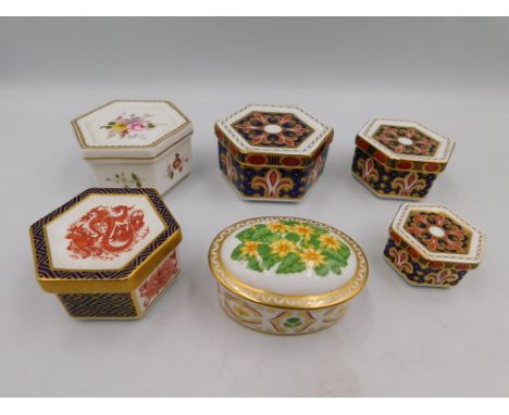 A collection of Royal Crown Derby trinket boxes to include; three hexagonal Imari patterned boxes, a Dragon patterned hexagon