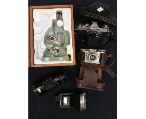 A collection of vintage cameras with separate lens along with a 1950s table top microscope in box.