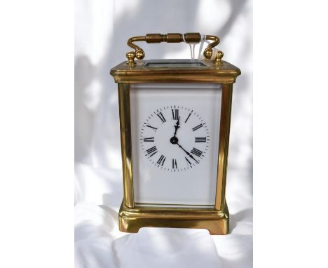 A 20th century brass carriage clock, not named and untested, with key. Excluding top handle approx. 11.3cm high.