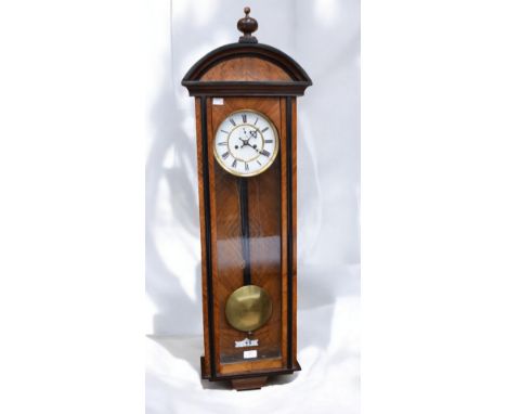 An early 20th century walnut veneered rectangular wall clock, with hinged glazed door, removable pediment with finial; white 