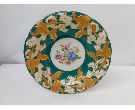 A 20th century Meissen green ground shallow bowl, decorated with scrolls of foliage with gilt detail, crossed swords mark und