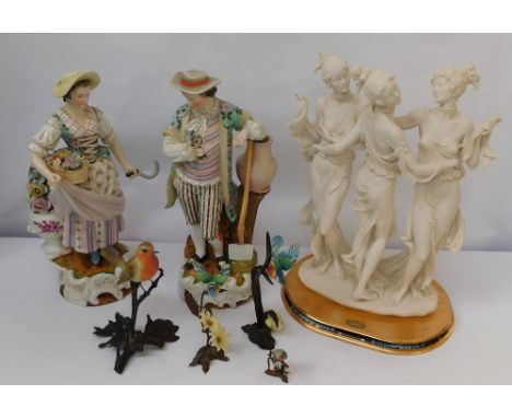 A pair of Continental porcelain figures of a gentleman and a lady, both unmarked; a Modern "Florence" resin figure of classic