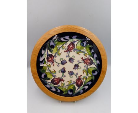 A Moorcroft Plaque in the Day Dream design by Nicola Slaney, in wooden surround, total diameter approximately 30.5cm,1st qual