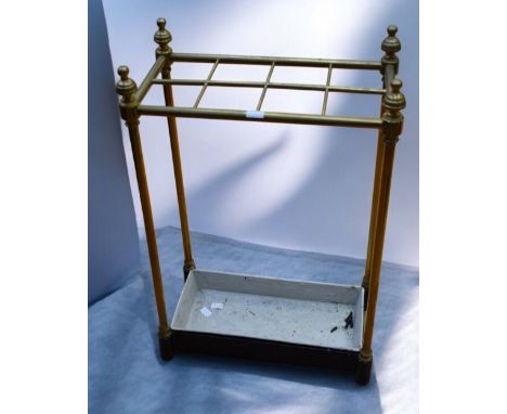 A solid brass mid 20th century stick-stand with a selection of walking sticks and umbrellas along with two golf putters and a