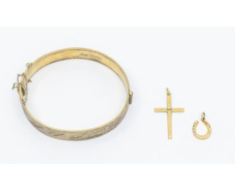 A Elizabeth II hallmarked silver hinged bangle; London 1953; weight approx 26.8gms, together with two 9ct yellow gold pendant