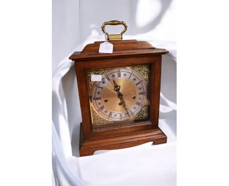 A late 20th century mahogany cased mantle clock, by Edward Miller, with gilt metal face and brass handle, untested.