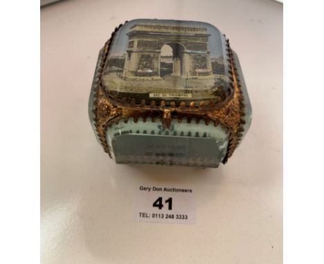 Small glass and metal trinket box with scene of Arc de Triomphe on lid. 3” (7.5cm) square.  Small chip on glass and slight sc