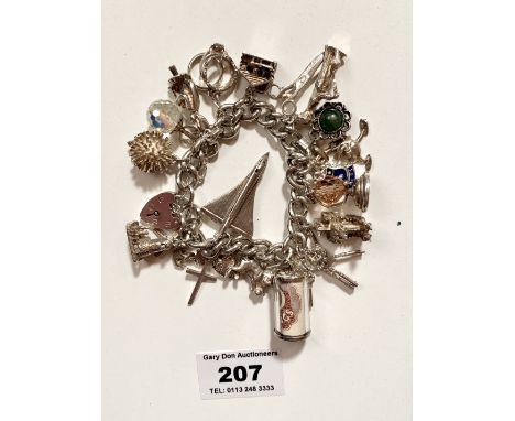 Silver charm bracelet with heart lock and 18 charms (some silver and some plated). Total w: 3.17 tozs.