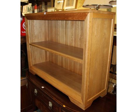 A contemporary light oak low freestanding open bookshelf, w.115cm 