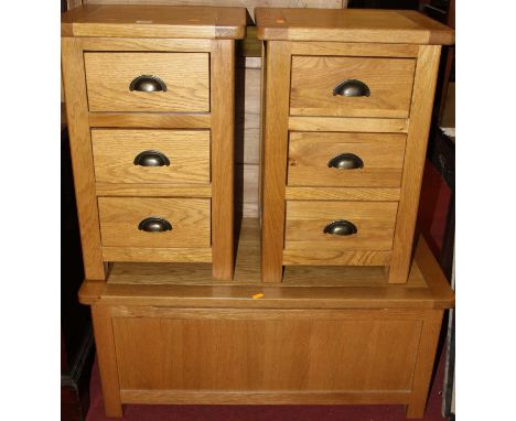 A pair of contemporary light oak round cornered three drawer bedside chests, each w.40.5cm; together with a matching hinge to
