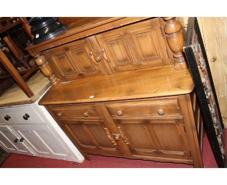 An Ercol mid-elm 'Golden Dawn' court cupboard, w.120cm