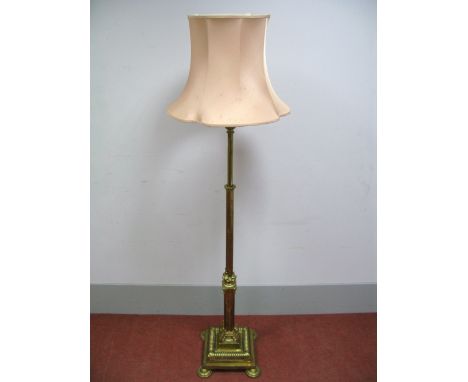 An Edwardian Brass Adjustable Standard Lamp, converted to electricity, the part-fluted circular section upper part on a flute
