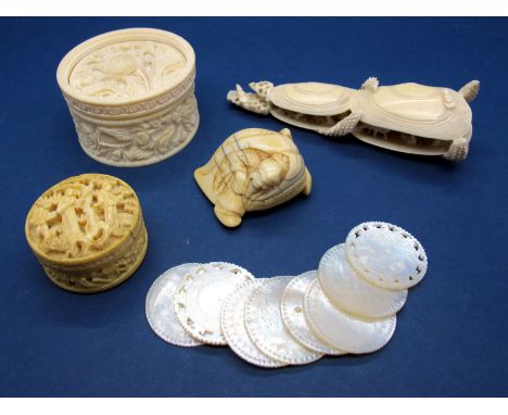 A Late XIX Century Chinese Ivory Box, containing mother of peal gaming tokens carved with figures on a terrace, 3cms diameter