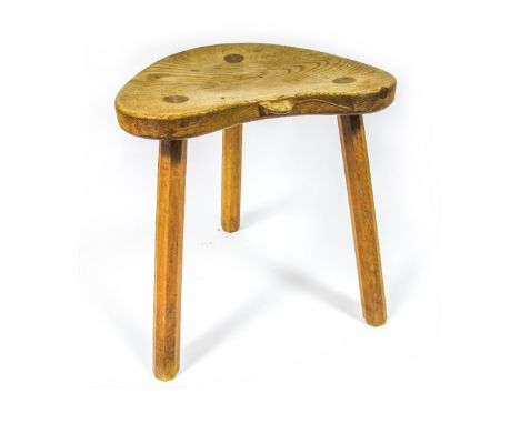 A Robert "Mouseman" Thompson Oak Milking Stool, the heart shaped top with carved mouse signature and raised on three splayed 