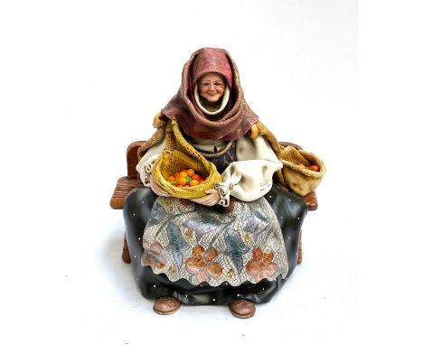 A Raffaello Sanfilippo figure of an old woman on a bench, 'Ricordo di Sardegna'
