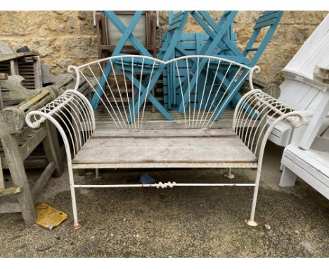 A white painted wrought metal garden bench, with outscrolled arms, 142cmW