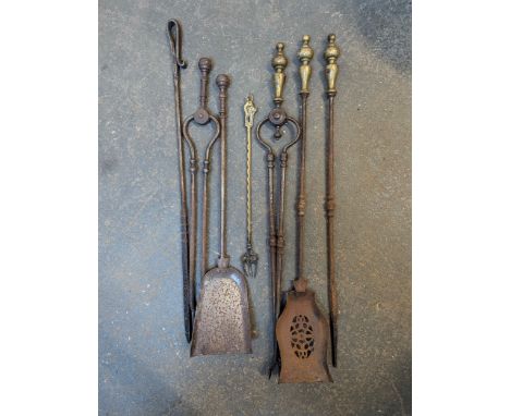 A quantity of fire tools to include a brass toasting fork with feline handle