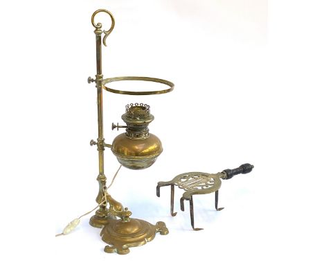 A 19th century brass oil lamp, converted for electricity; together with a small brass and steel trivet in the form of a lyre,