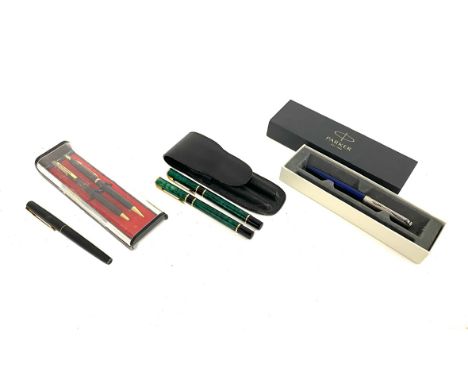 A leather cased Waterman fountain pen and ballpoint pen in malachite pattern; two Parker pens and two others