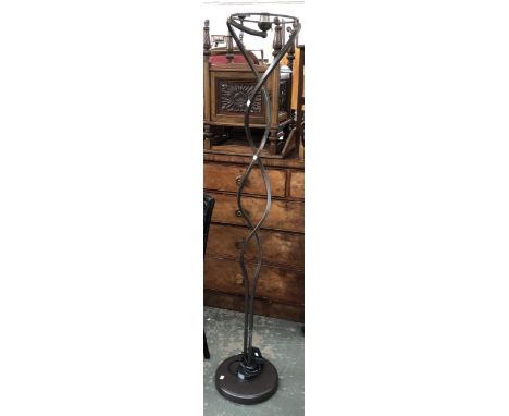 A wrought metal spiralled standing lamp, 175cmH