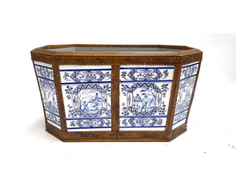 Interior design interest: a ceramic and copper octagonal planter, with liner, the blue and white Delft style tiles depicting 