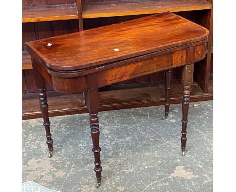 A 19th century mahogany card table, on turned tapering legs and brass casters, 91x45x73cmH