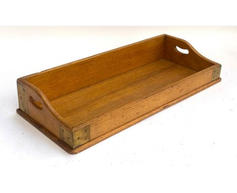A light oak and brass bound twin handled book trough, 66cmW