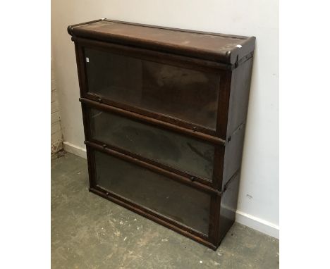 A Globe Wernicke co. ltd oak three section glazed bookcase, 87cmW, 27cmD, 101cmH