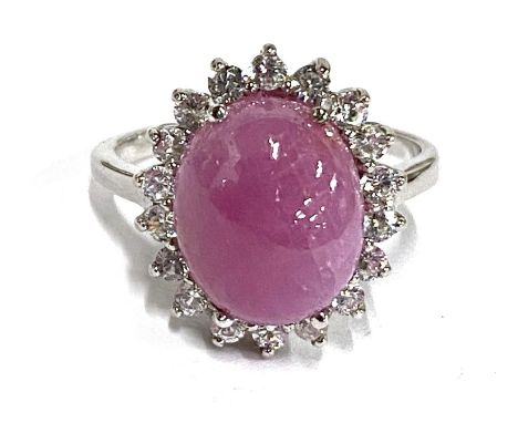 A silver ring set with a ruby cabochon and white zircons, size P and size S, 7.6g