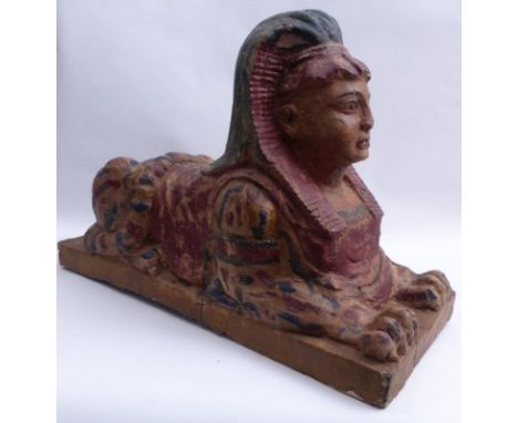   Sphinx  19. Jh.  Auf Plinthe liegende Sphinx. Holz, farbig gefasst. 71 x 49 x 30 cm. - Altersspuren,  Farbverluste.  Kerami